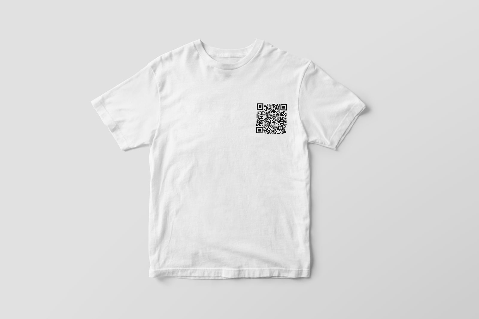 Front of a white t-shirt with a small chest QR code
